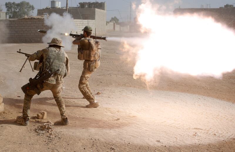 Members of an Iraqi special forces police unit fire at ISIS.  Reuters