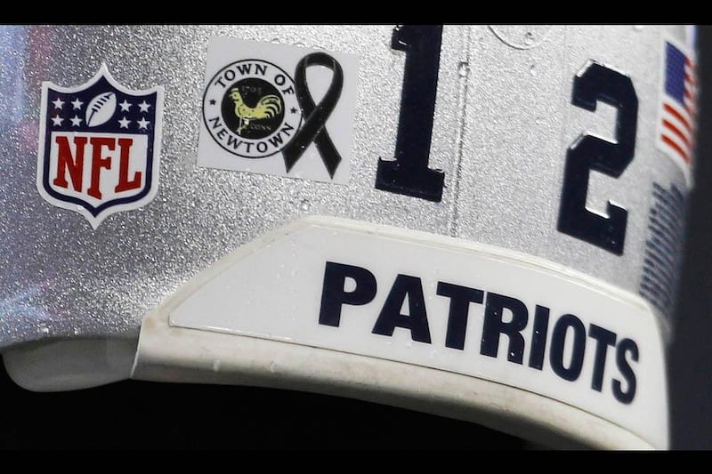 Patriots quarterback Brady wears a decal on his helmet in tribute to the victims of a gunman's elementary school rampage at the Sandy Hook Elementary School in Newtown, Connecticut. Jessica Rinaldi / Reuters