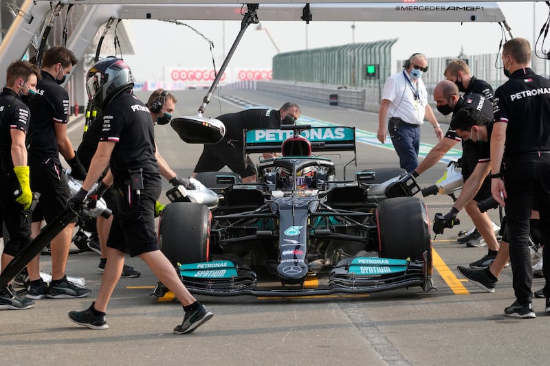 Mechanics work on Lewis Hamilton's car in Qatar. AP