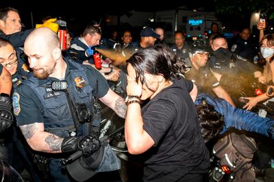Metropolitan Police use pepper spray on demonstrators at George Washington University on Wednesday. AP