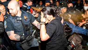Officers of the Metropolitan Police Department pepper spray demonstrators at George Washington University, on May 8, 2024, in Washington.  AP