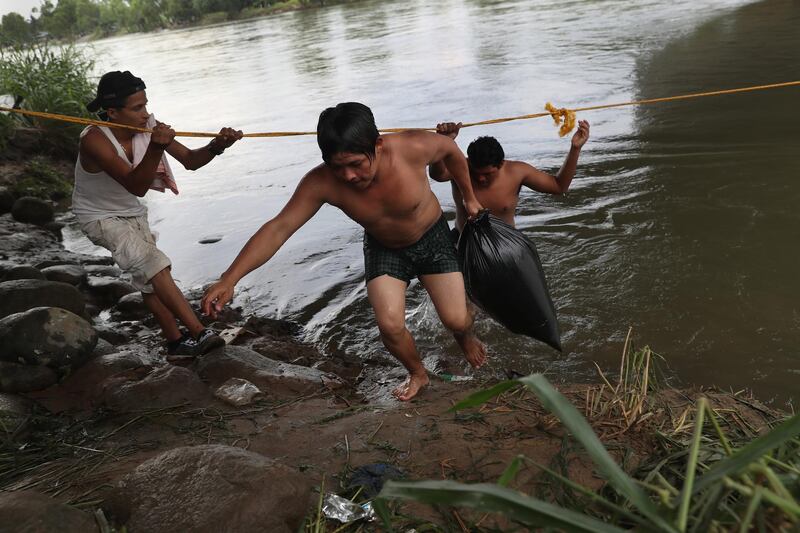 A group successfully wades across the river.  Getty