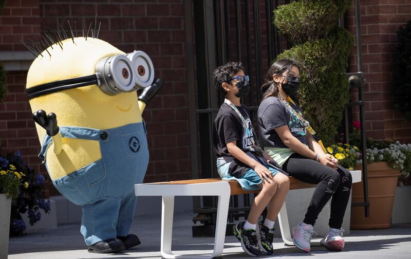Guests pose with a Minion character on the reopening day of Universal Studios Hollywood during the outbreak of the coronavirus disease, in Universal City, California, US. Reuters