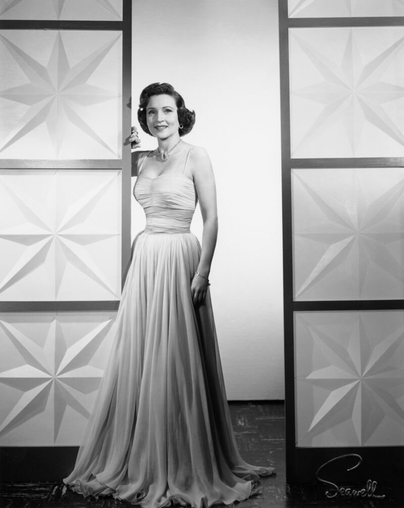 Betty White, in a pale gown, on a TV set in 1958. Reuters