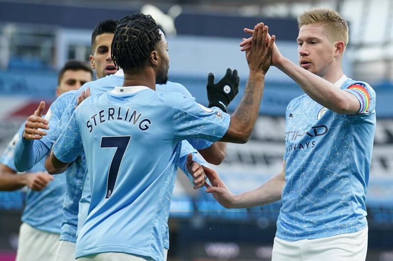 Manchester City's Raheem Sterling celebrates with Kevin De Bruyne after scoring the opening goal in their 2-0 win over Fulham at the Etihad Stadium on Saturday, December 6. AP