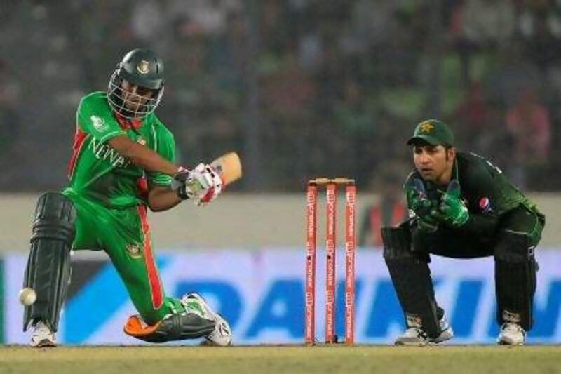 Bangladeshi batsman Shakib Al Hasan, left, plays a shot as the Pakistan wicketkeeper Sarfraz Ahmed looks on. Al Hasan and his teammates fell two runs short of Bangladesh's first Asia Cup title.