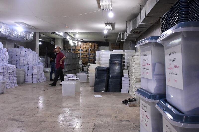 A Syrian man looks at ballot boxes, ahead of handing them over to the police to deliver them to polling stations on the eve of the parliamentary elections, in the Syrian city of Aleppo on July 18, 2020. More than 7,400 polling stations will open at 0430 GMT in government-held parts of Syria, including for the first time in former opposition strongholds. / AFP / -
