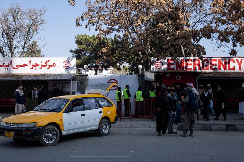 People wait outside Kabul's Emergency Hopsital in Share-Naw where at least 30 injured have been brought. 