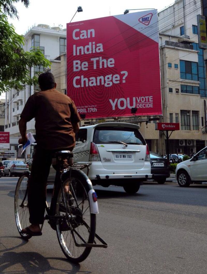 Vehicles pass by a billboard which says ‘Can India be Change — You Vote, You Decide’ meant to generate participation for the upcoming Lok Sabha election in Bangalore. Jagadeesh NV / EPA