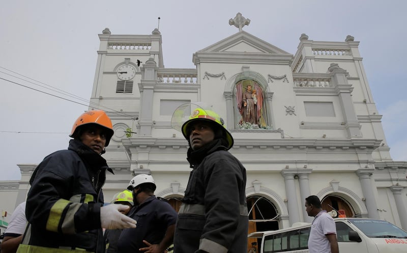 Sri Lankan firefighters stand in the area around St Anthony's Shrine.  AP