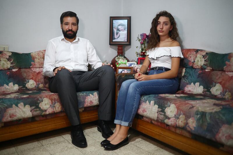 Elie Hasrouty and Tatiana Hasrouty pose for a photograph as they wait for news about their father Ghassan Hasrouty. Reuters