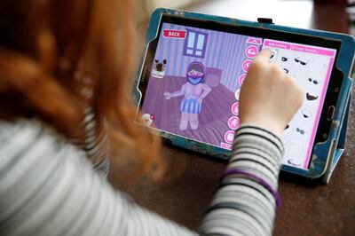 A young girl plays 'Roblox' at her home in Manchester. Zoomers are active in the metaverse and spend money on items for their avatars. Reuters