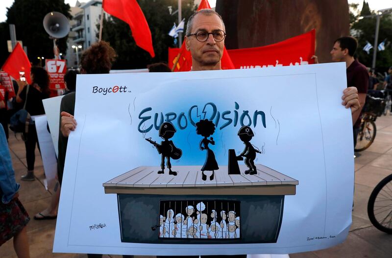 Left wing Israelis hold slogans during a protest against Eurovision in Tel Aviv. While Israel's 2018 Eurovision victory with Netta Barzilai's "Toy" meant the Jewish state would host the next year. 
 AFP