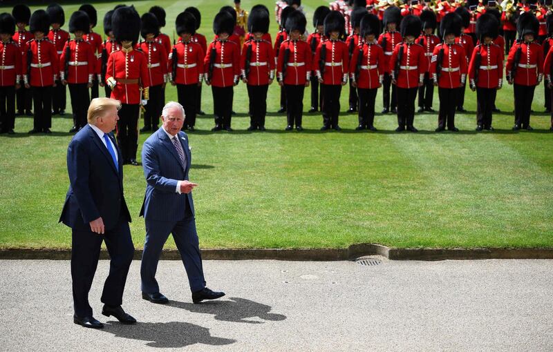 US President Donald Trump (L) walks with Britain's Prince Charles, Prince of Wales after inspecting the honour guard during a welcome ceremony at Buckingham Palace in central London on June 3, 2019, on the first day of the US president and First Lady's three-day State Visit to the UK.  AFP