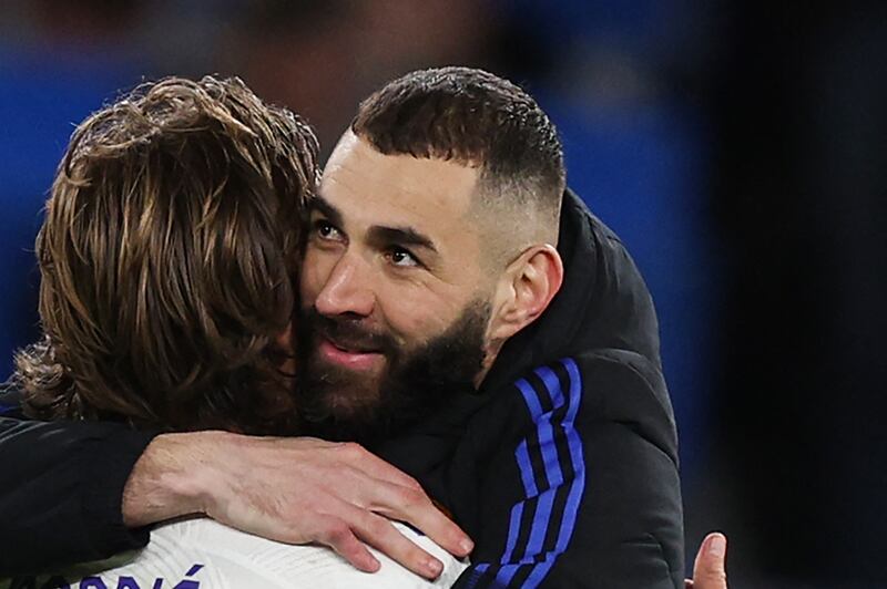 Karim Benzema and Luka Modric celebrate after winning at  Chelsea.  AFP