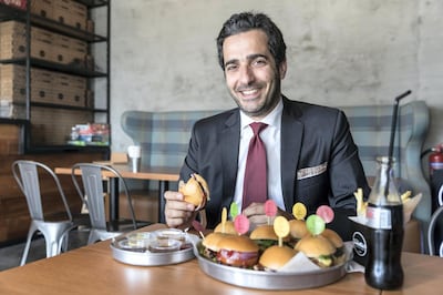 DUBAI, UNITED ARAB EMIRATES. 09 JANUARY 2018. Burger lover Firas Sfair, an architect from Lebanon, at the Smokin’9 mini burger restaurant in JLT Cluster U. (Photo: Antonie Robertson/The National) Journalist: Hala Khalaf. Section: Arts and Culture.