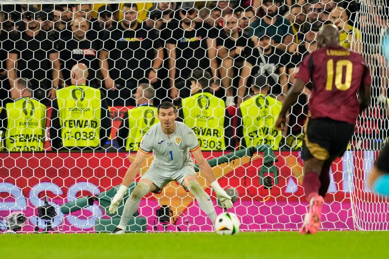 Romania's goalkeeper Florin Nita looks on as Belgium's Romelu Lukaku tucks away a shot that led to a disallowed goal. AP