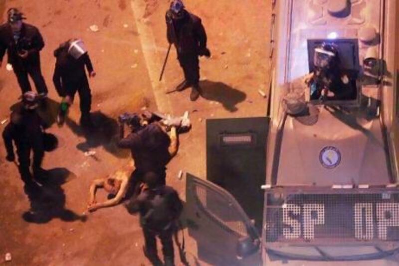 Egyptian riot police stripped a man, beat him and then dragged him into a police van during clashes in Cairo. "Next thing you know, the martyr killed yesterday will rise from the dead and say he wasn't shot," says lawyer Achraf Shazly.