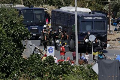 Police block an area where refugees and migrants from the destroyed Moria camp are sheltered, during an operation to move them to a new temporary camp, on the island of Lesbos, Greece, September 17, 2020. REUTERS/Elias Marcou