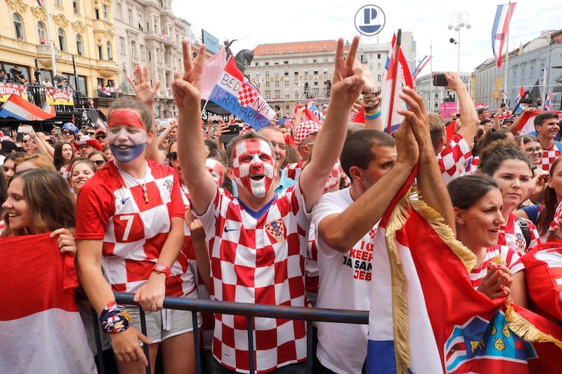 Supporters cheer while waiting for the arrival of the Croatian national football team in central Zagreb. Antonio Bat /  EPA