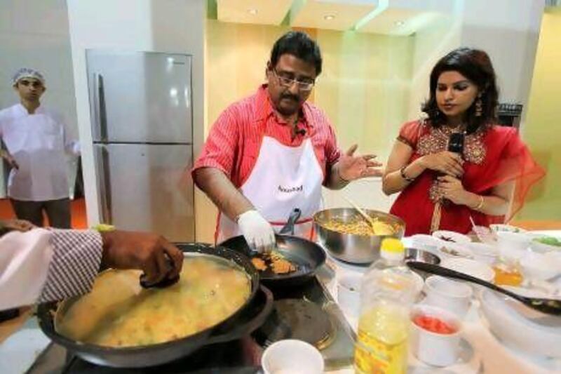 Naushad, or the Big Chef, from Kerala, makes kuttanadan chicken roast at the Sharjah International Book Fair. Pawan Singh / The National