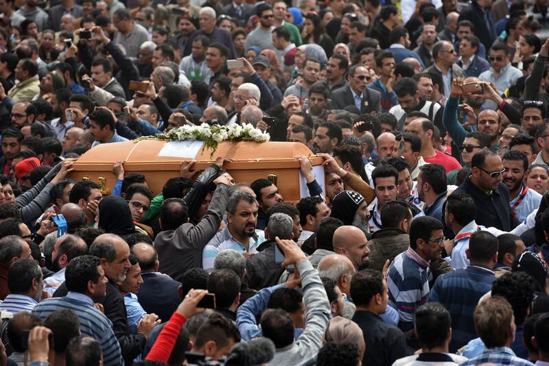 Mourners carry the coffin of one of the victims of the blast at the Coptic Christian Saint Mark's church in Alexandria. Mohamed El-Shahed / AFP 