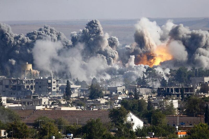 Smoke rises over the Syrian town of Kobani after an air strike last October, as seen from the Mursitpinar crossing on the Turkish-Syrian border. Kai Pfaffenbach/Files/Reuters