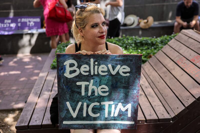 An Israeli activist holds a sign in Jerusalem to protest against rape culture. AFP