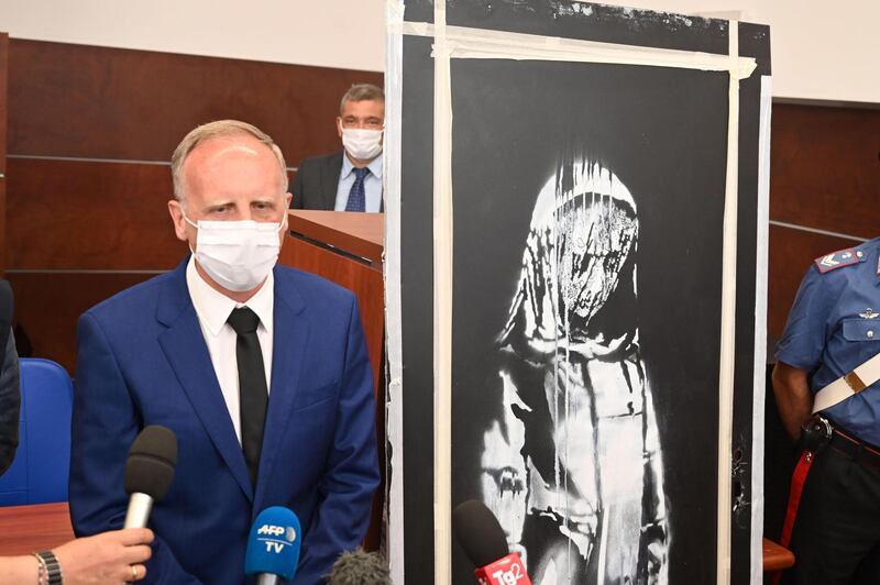 epa08479512 Major Cristophe Cencig, liaison officer for organized crime at the French Embassy in Italy, during a press conference about the piece of art attributed to Banksy, that was stolen at the Bataclan in Paris in 2019, and found in Italy, in l'Aquila, Italy, 11 June 2020. British street artist Banksy's tribute to the 2015 Bataclan massacre survivors, stolen from outside the Paris theatre in January last year, was presented at the press conference after being found in the attic of a farmhouse near Teramo in Abruzzo.  EPA/CLAUDIO LATTANZIO