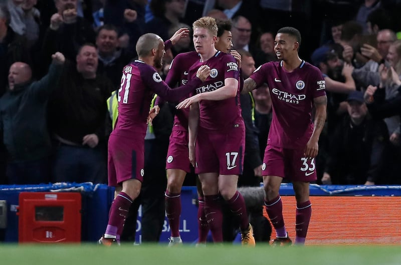 Manchester City's Kevin De Bruyne, centre is congratulated by his teammates after scoring the opening goal of the game during their English Premier League soccer match between Chelsea and Manchester City at Stamford Bridge stadium in London, Saturday, Sept. 30, 2017. (AP Photo/Kirsty Wigglesworth)