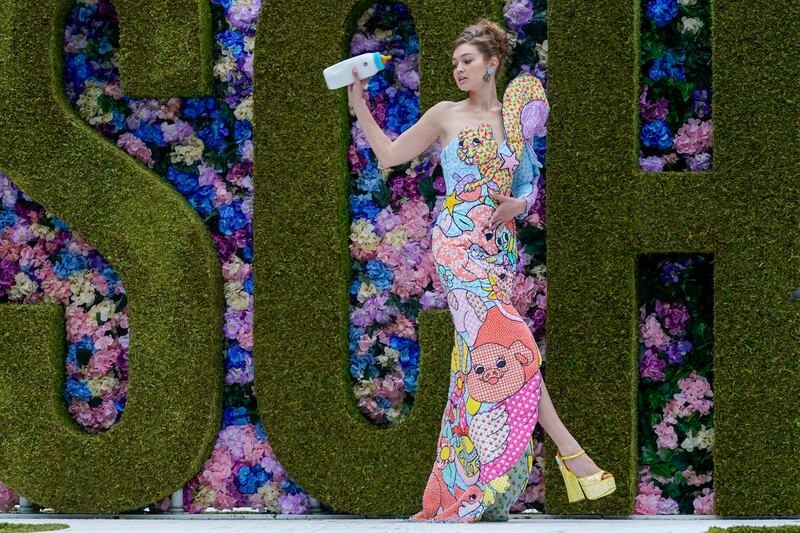 New mum Gigi Hadid holds a baby bottle purse on the runway at Moschino's Spring/Summer 2022 collection showcase at New York Fashion Week.  AP