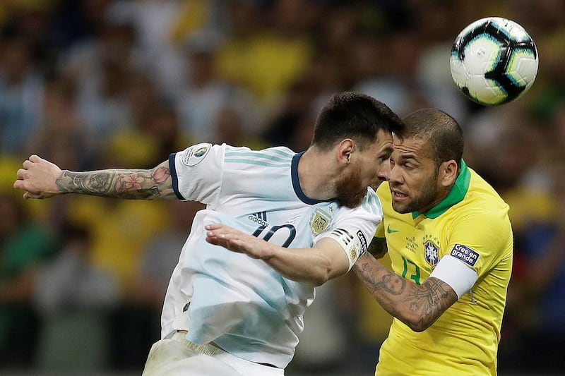 Brazil's Dani Alves, right, in action against Argentina's Lionel Messi. AFP