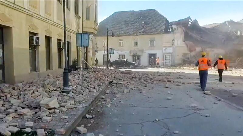 A grab of a video taken and released by the Croatian Red Cross on shows people looking through the rubbles and rescuing victims in the streets of Petrinja, after the town was striked by an earthquake of 6,4 magnitude.  AFP