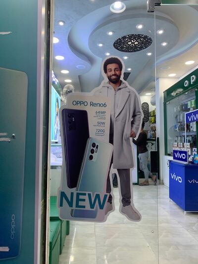 An advertisement featuring Mohamed Salah on the door of a mobile phone store in his native village of Nagrig. Photo: Hamza Hendawi / The National