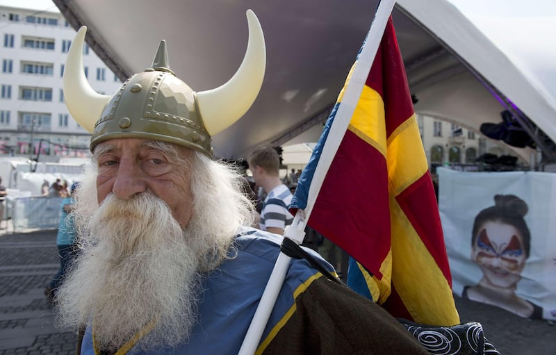 A Malmo resident dressed in a viking costume holds a  composite "scandinavian" flag at a Eurovision public viewing area in downtown Malmo ahead of the finals of the 2013 Eurovision Song Contest on May 18, 2013. AFP PHOTO AFP PHOTO / JOHN MACDOUGALL
 *** Local Caption ***  143364-01-08.jpg
