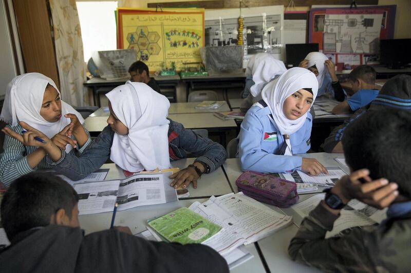 Beduin children studying Science in the elementary school in the tiny West Bank Beduin village of Khan al-Ahmar  on May 2,2018.The Israeli Supreme Court is expected next week to rule on the fate of the village, situated east of Jerusalem between the expanding settlements of Maale Adumim and Kfar Adumim.  The Israeli state says Khan al-Ahmar must be leveled because its structures are situated on state land and were built without permits, which are nearly impossible to obtain in the part of the West Bank known as area C, under full Israeli control.(Photo by Heidi Levine for The National).