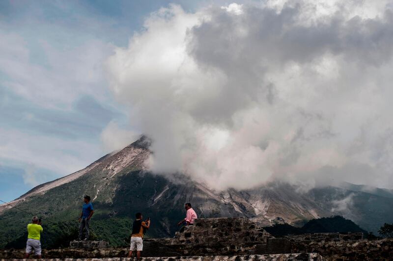 People watch as Indonesia’s most active volcano Mount Merapi spews rocks and gas in Yogyakarta. AFP