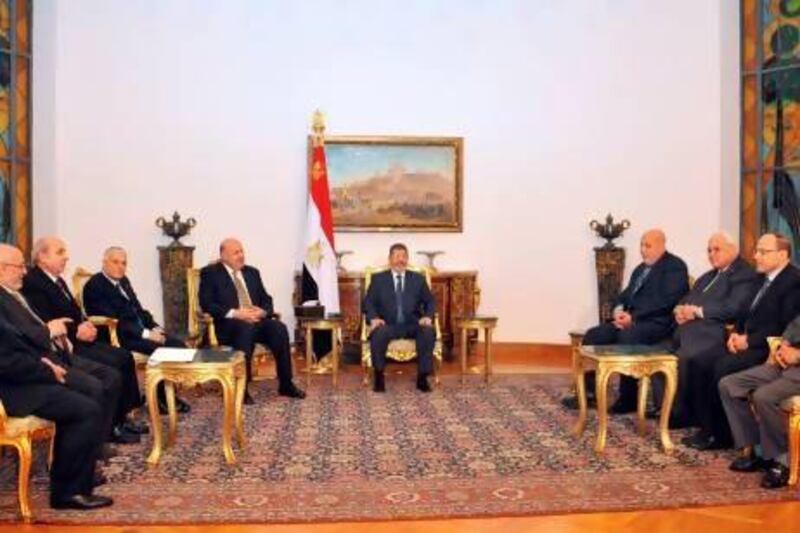 Egyptian president Mohammed Morsi (centre) met with officials and the High Council of Justice in Cairo. An Egyptian court will next week examine the legality of a decree by which Mr Morsi granted himself sweeping powers.