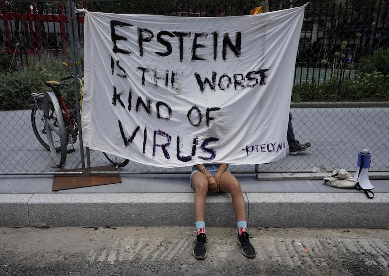 A protester outside court when Maxwell made her first appearance in July 2020. AFP