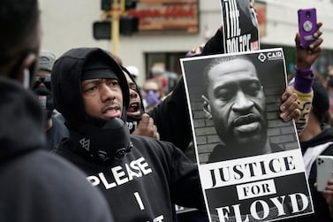 Actor and comedian Nick Cannon celebrates the memory of George Floyd and demands justice outside the Cup Foods store on Chicago Avenue in Minneapolis. Brian Peterson / Star Tribune via AP