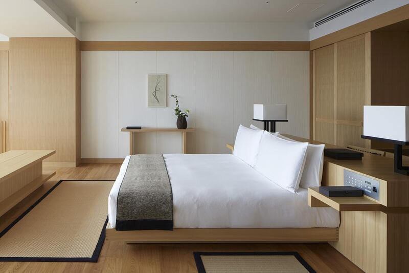 A suite bedroom. With floor-to-ceiling windows and sweeping city views, the rooms and suites are outfitted with traditional Japanese furnishings, from washi paper sliding doors to deep soaking tubs. Free Wi-Fi and flat-screen TVs are included. Courtesy Aman Resorts