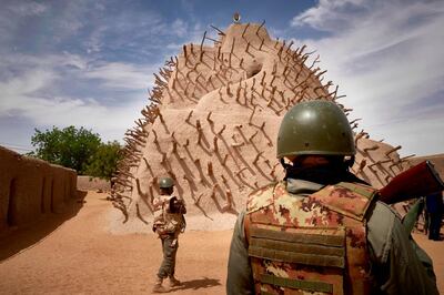 Soldiers of the Malian army patrol the archaeological site of the Tomb of Askia in Gao on March 10, 2020.  The site, which was protected during the 10 months of jihadist occupation in 2012, represents one of the finest examples of Sudano-Sahelian architecture in the Sahel region. / AFP / MICHELE CATTANI

