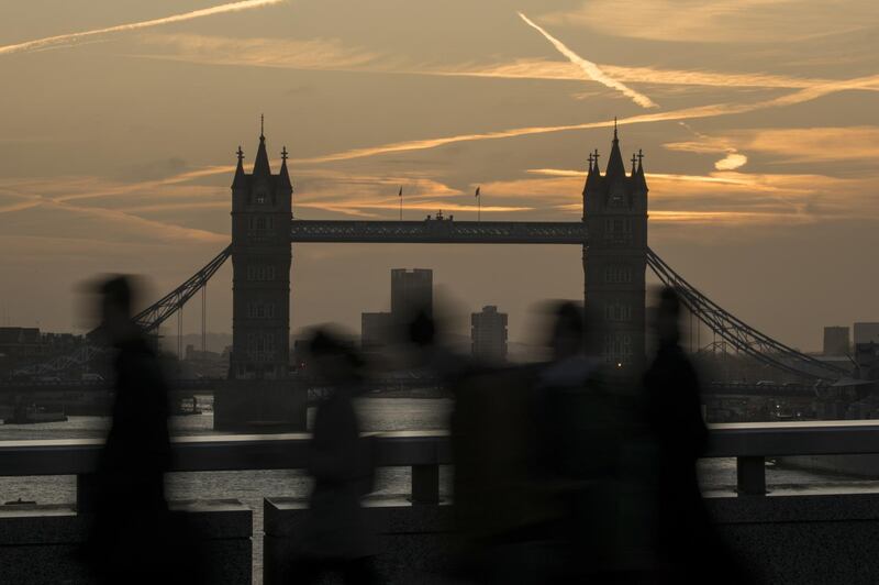 Morning commuters walk across London Bridge in view of Tower Bridge in London, U.K., on Monday, Feb. 3, 2020. London is still 'where it happens' for European finance, William Russell, the Lord Mayor of London says. Photographer: Jason Alden/Bloomberg