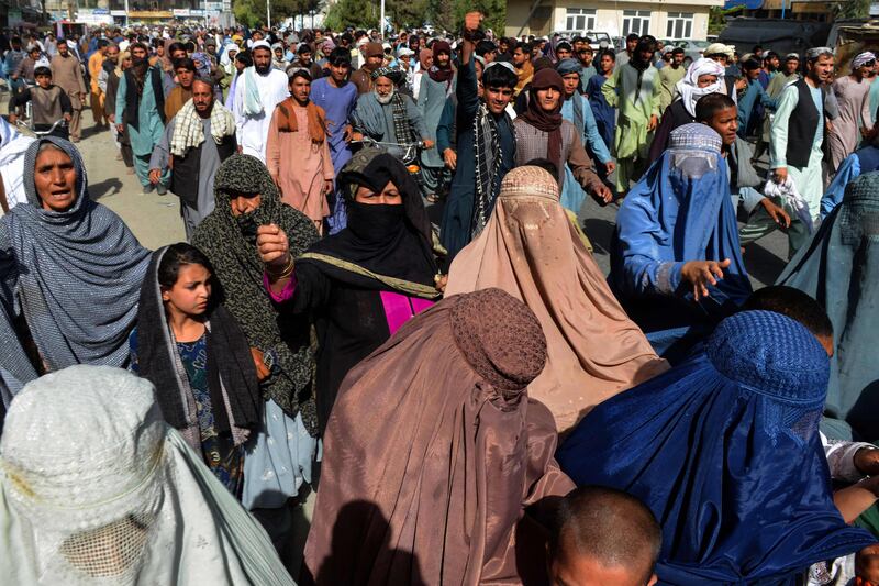 Local residents take part in a protest march against a reported announcement by the Taliban, asking them to evict their homes built on state-owned land in Kandahar.  AFP