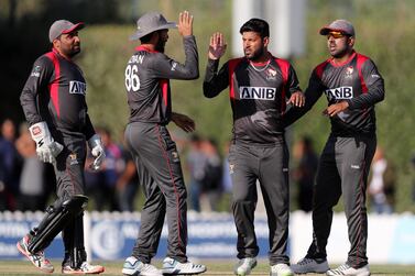 UAE captain Mohammad Naveed, second right, celebrates after taking the wicket of Nepal's Sompal Kami in their T20 clash in January. Chris Whiteoak/The National