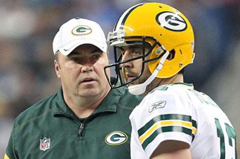 Aaron Rodgers, right, credits his head coach, Mike McCarthy, for keeping the team on a regular schedule from week to week, so that they don't look past any game.