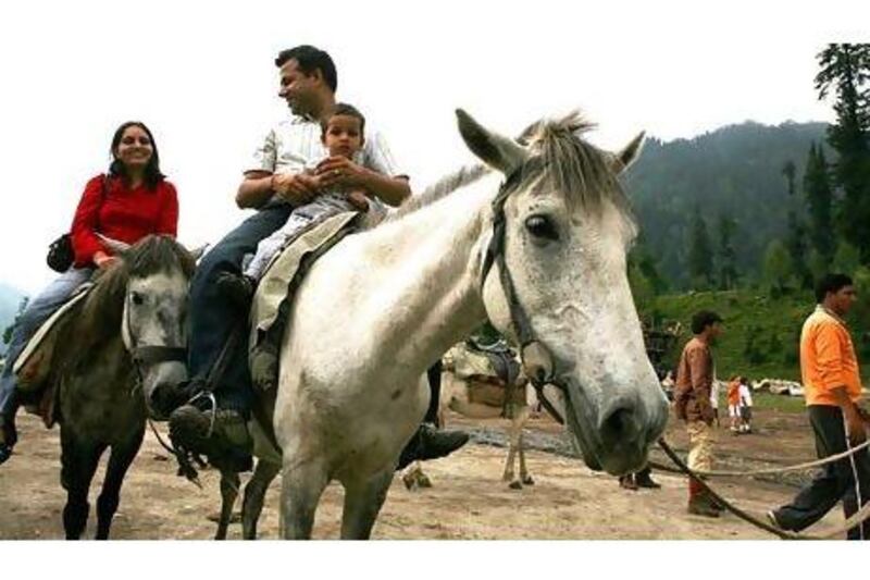 Tourists enjoy horse riding in the Solang Valley in India's Himachal Pradesh state. The growing affluence of India's middle class has led to an increase in the uptake of holidays both domestically and internationally. Pawan Singh / The National