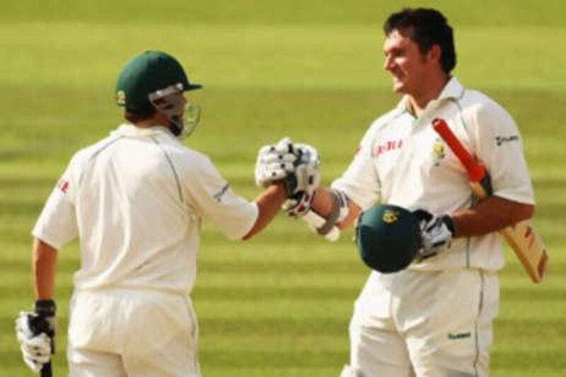 Neil McKenzie (left) congratulates the South Africa captain Graeme Smith on his century.