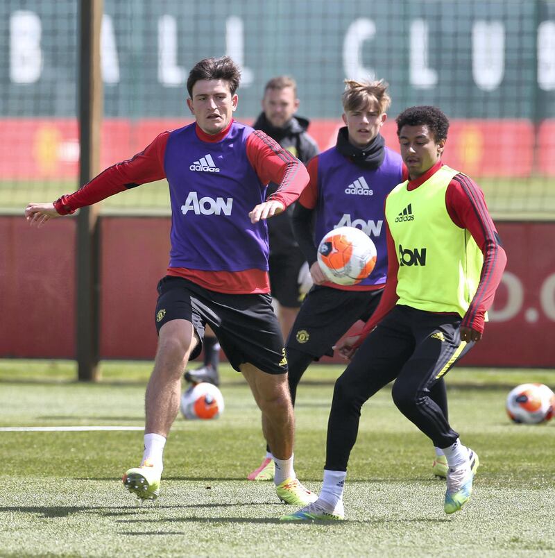 MANCHESTER, ENGLAND - JUNE 05: Harry Maguire and Jesse Lingard of Manchester United in action during a first team training session at Aon Training Complex on June 05, 2020 in Manchester, England. (Photo by Matthew Peters/Manchester United via Getty Images)
