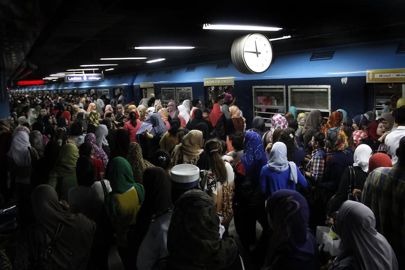 Egyptian women board a train at Al Shohadaa, (Martyrs) metro station.